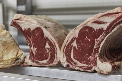 Two mirrored racks of beef waiting to be sold online